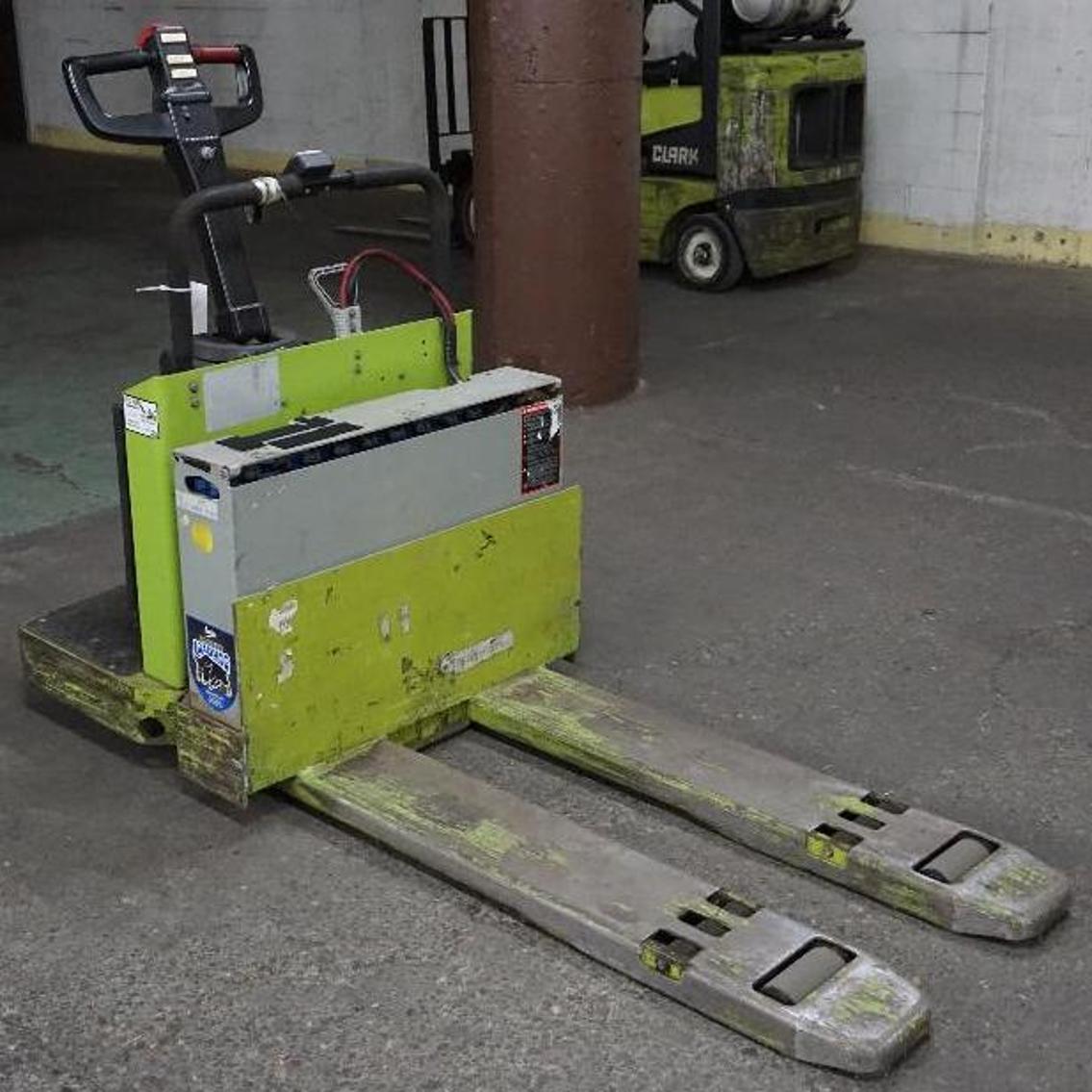 (8) Electric Pallet Jacks, Clark Forklift, Tennant Sweeper, and Pallet Racking