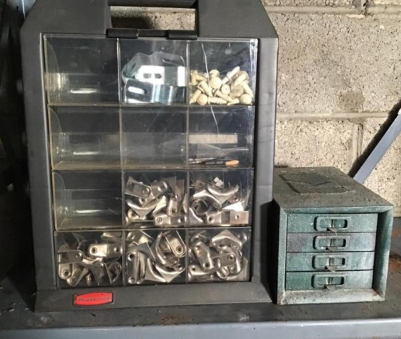 Image for Drill Bits In Metal Box And A Container With Corner Braces And Wall Anchors